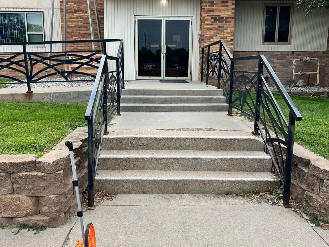 Professional concrete steps with decorative railings